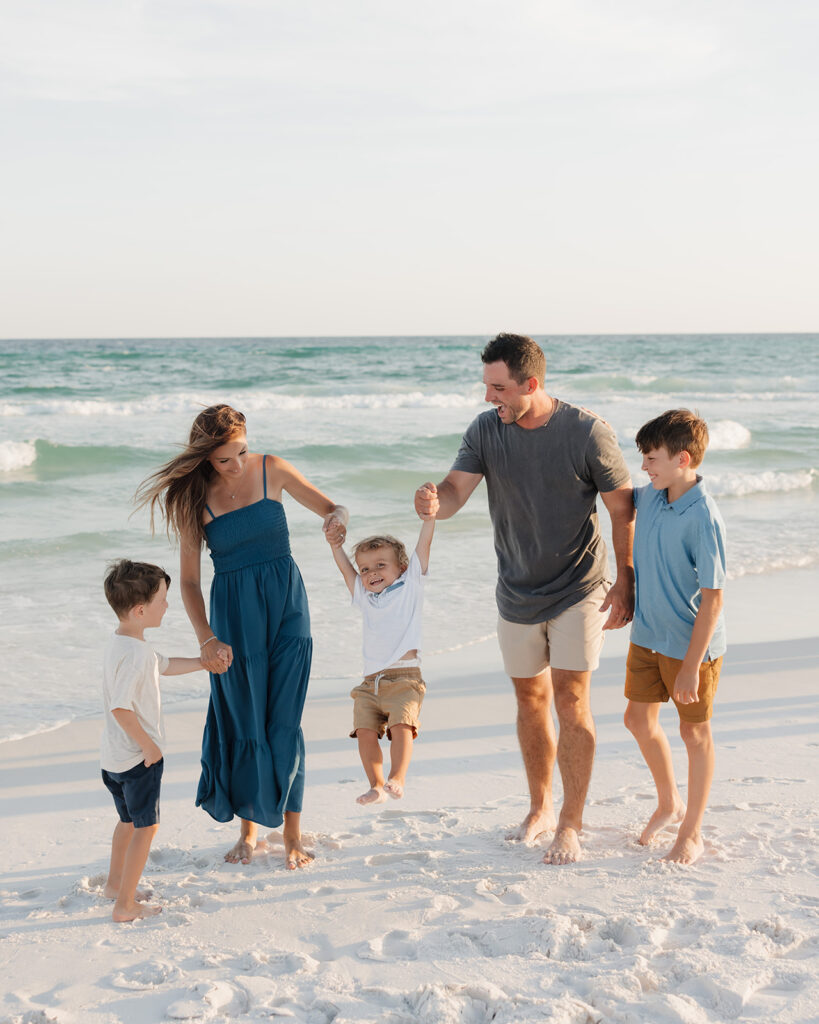 family of five plays on Seaside Florida beach