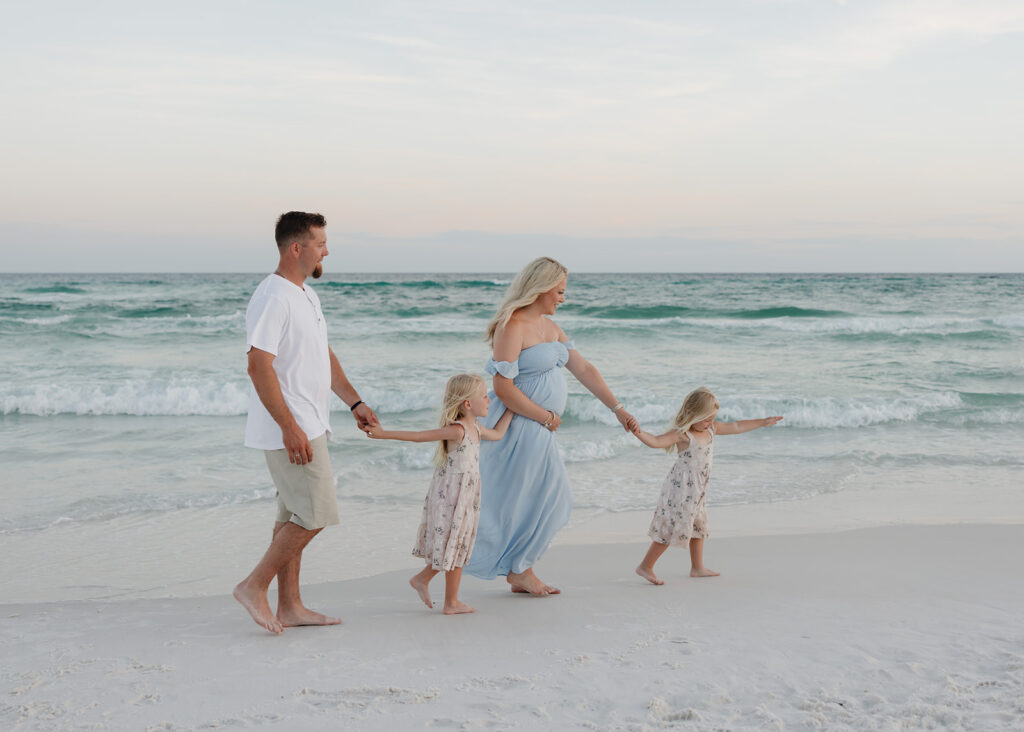 family of four walks on the 30A beach