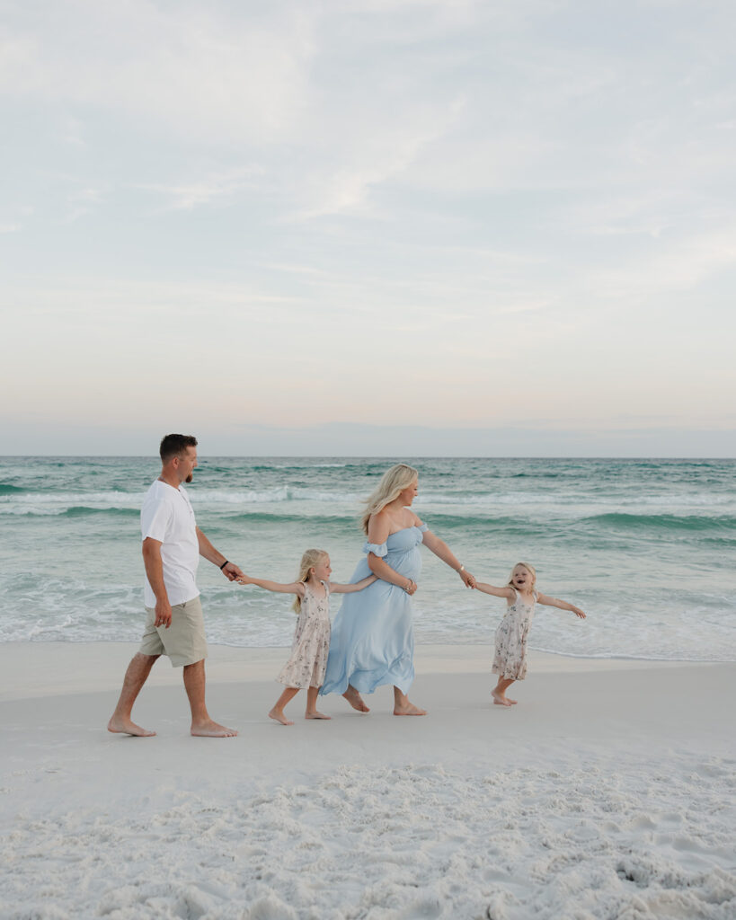 family walks on the beach of 30A