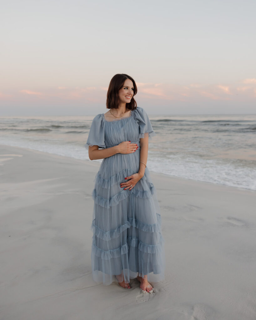 woman poses for photographer on Santa Rosa Beach