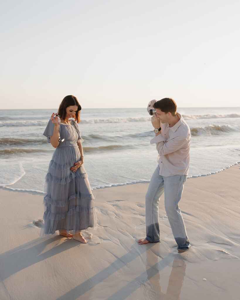 man takes a photo of woman on Seaside FL beach