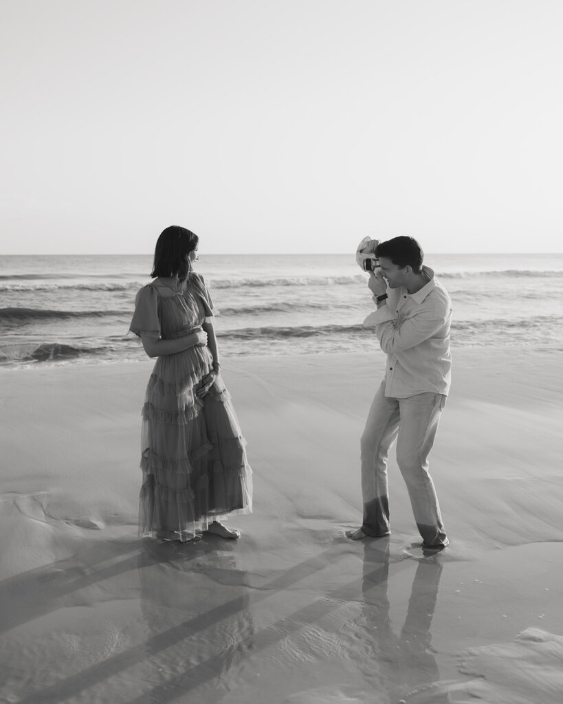 man takes a photo of woman on Santa Rosa Beach