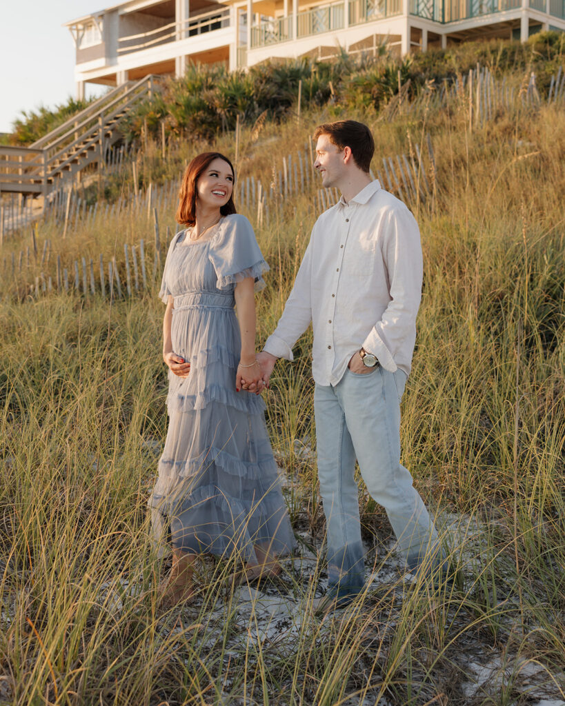 woman and man walk on the beach