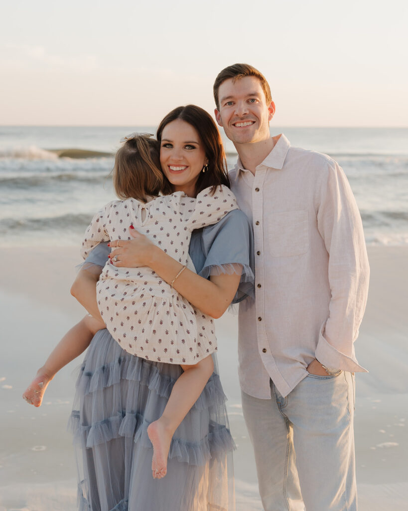 family smiles for photos in Seaside Florida