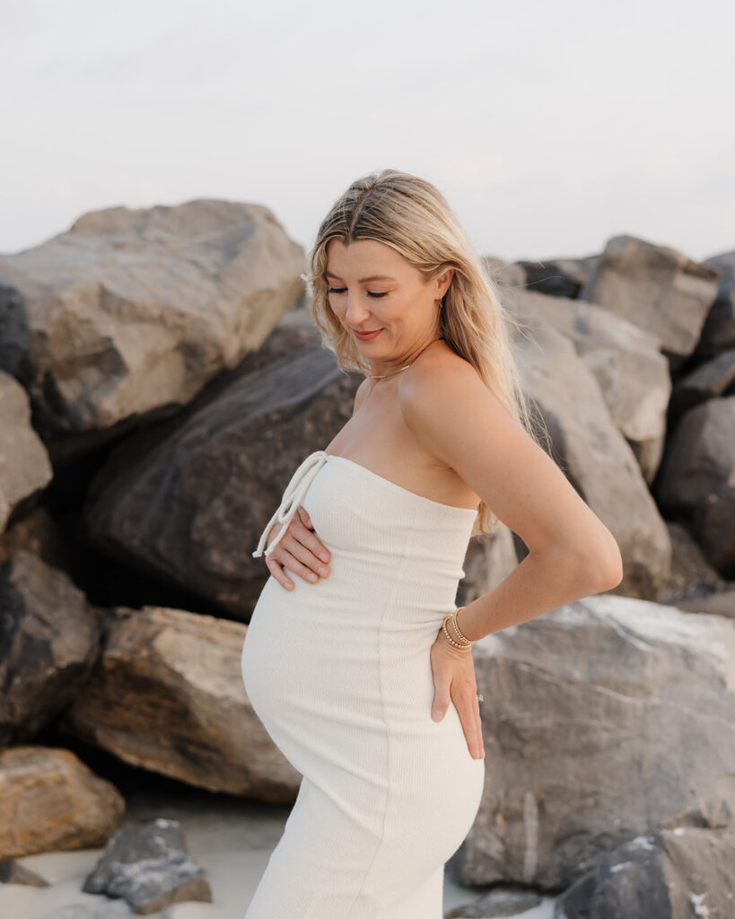 woman smiles at her baby bump