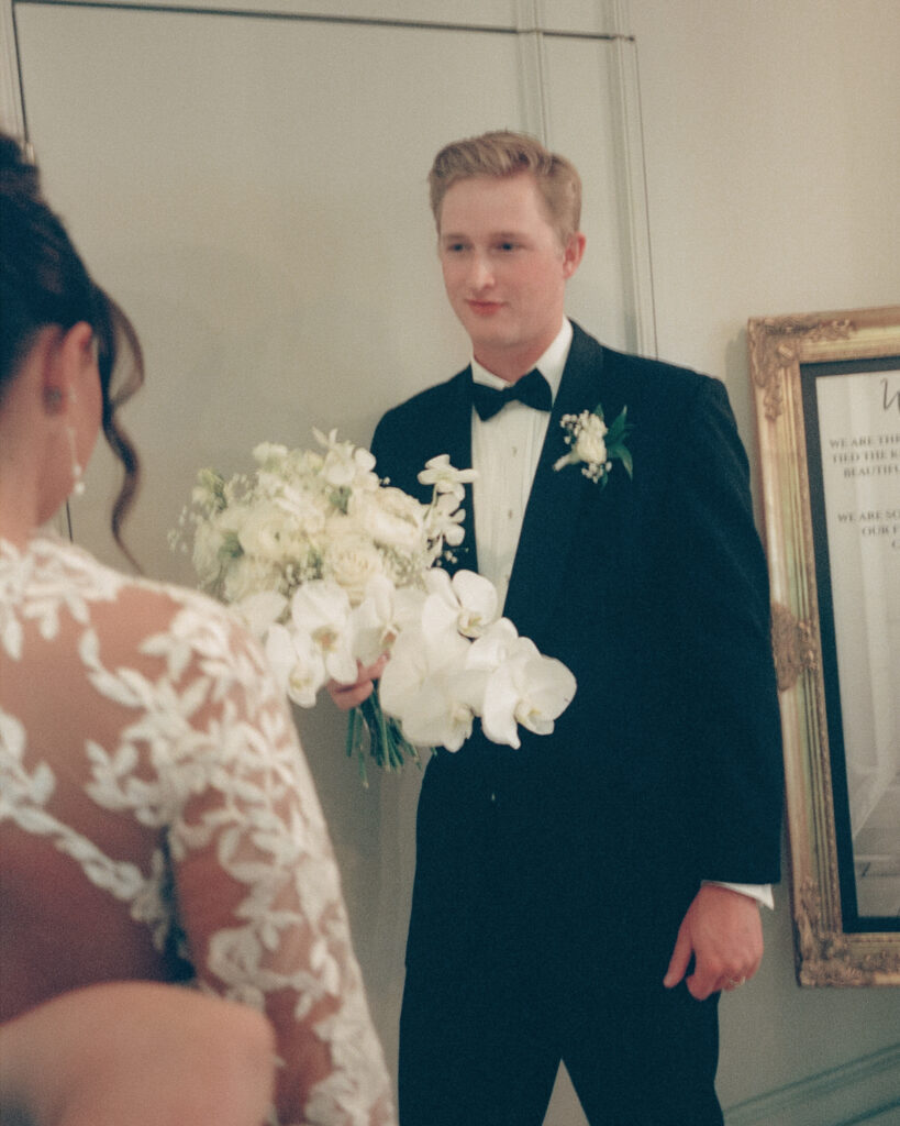 groom watches bride