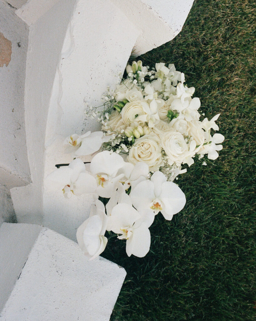 wedding bouquet sits on the steps of the Sanctuary event venue