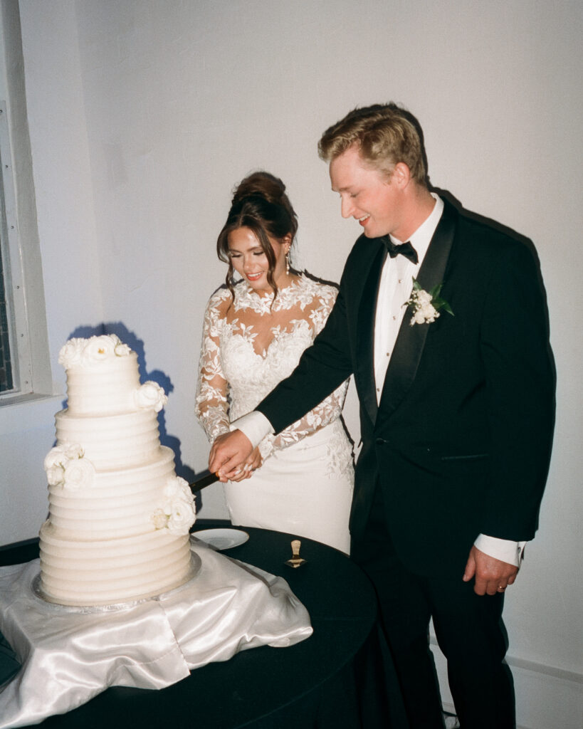 bride and groom cut their cake