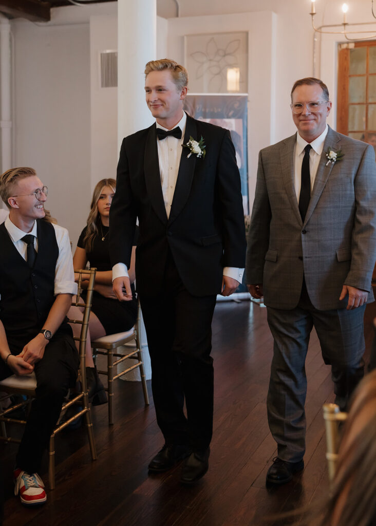 groom walks down the aisle