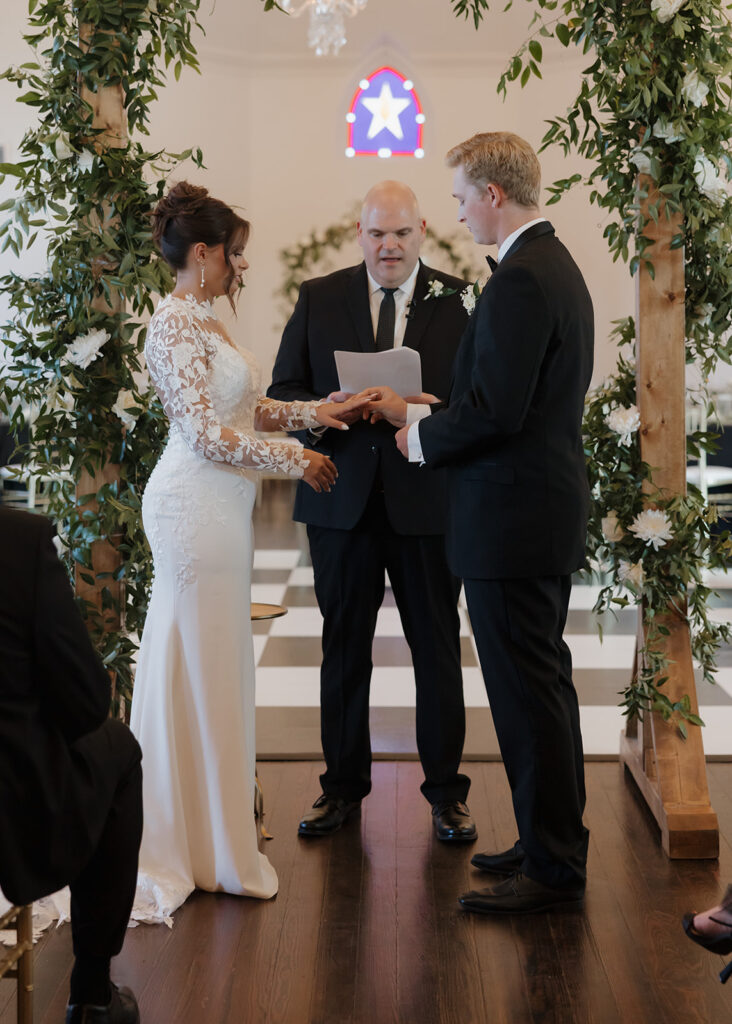 bride and groom exchange rings at the Sanctuary event venue