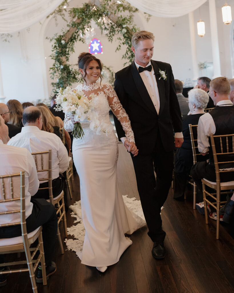 bride and groom walk out of the ceremony