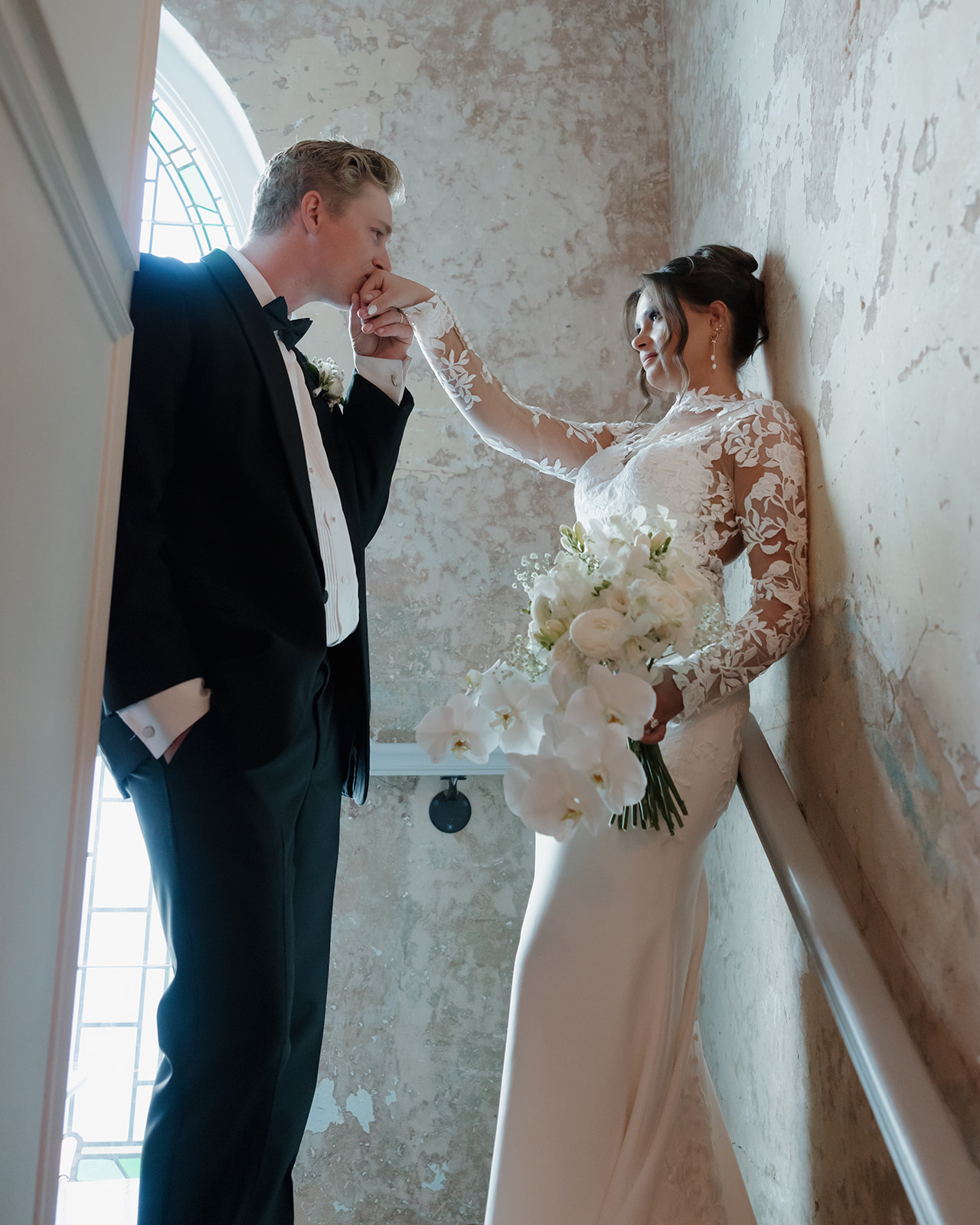 groom kisses bride's hand