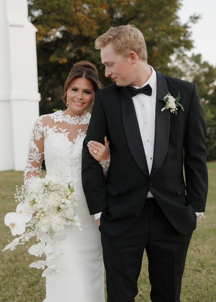 bride smiles while holding onto groom