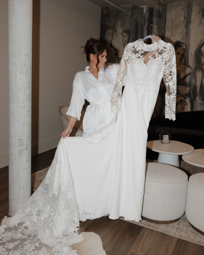 bride carries her wedding dress