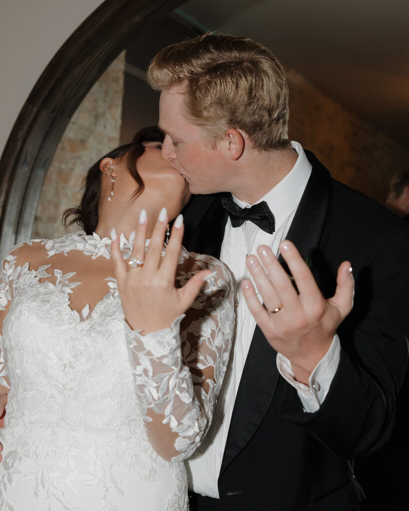 bride and groom show their wedding rings