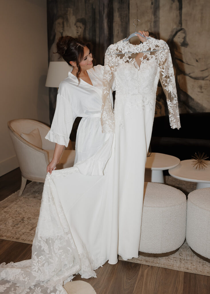 bride smiles at her wedding dress