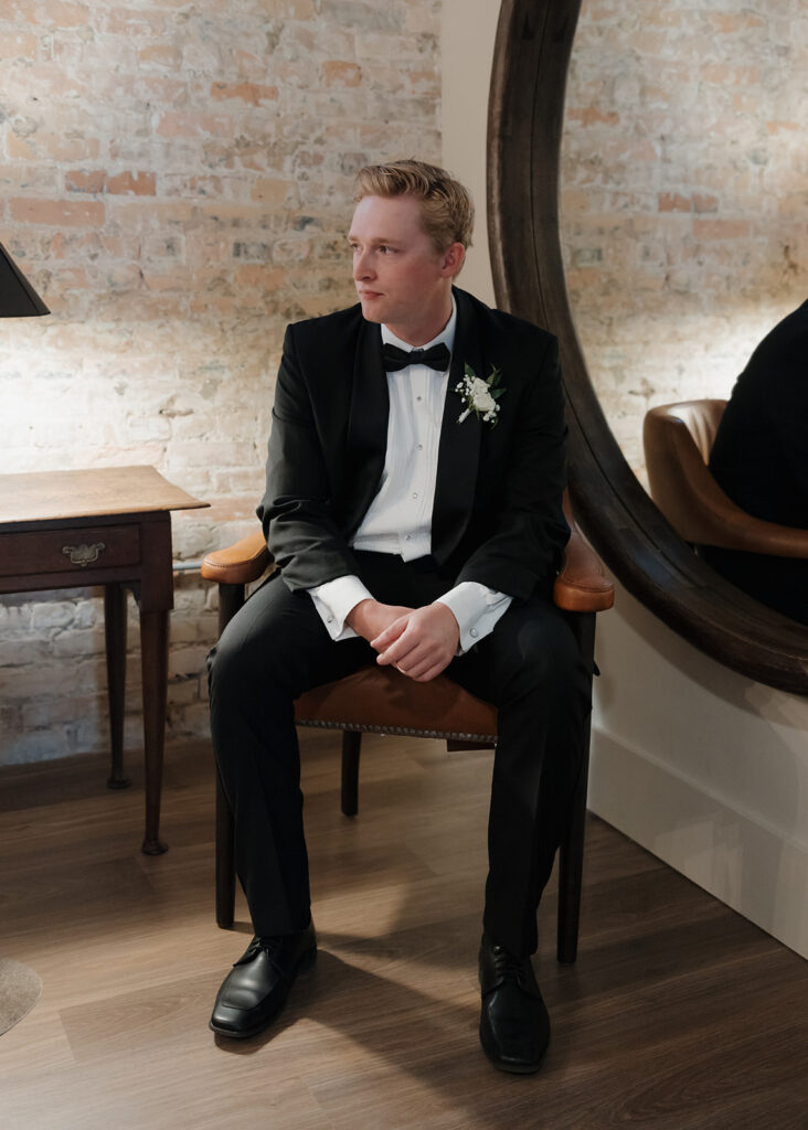 groom sits in the groom suite