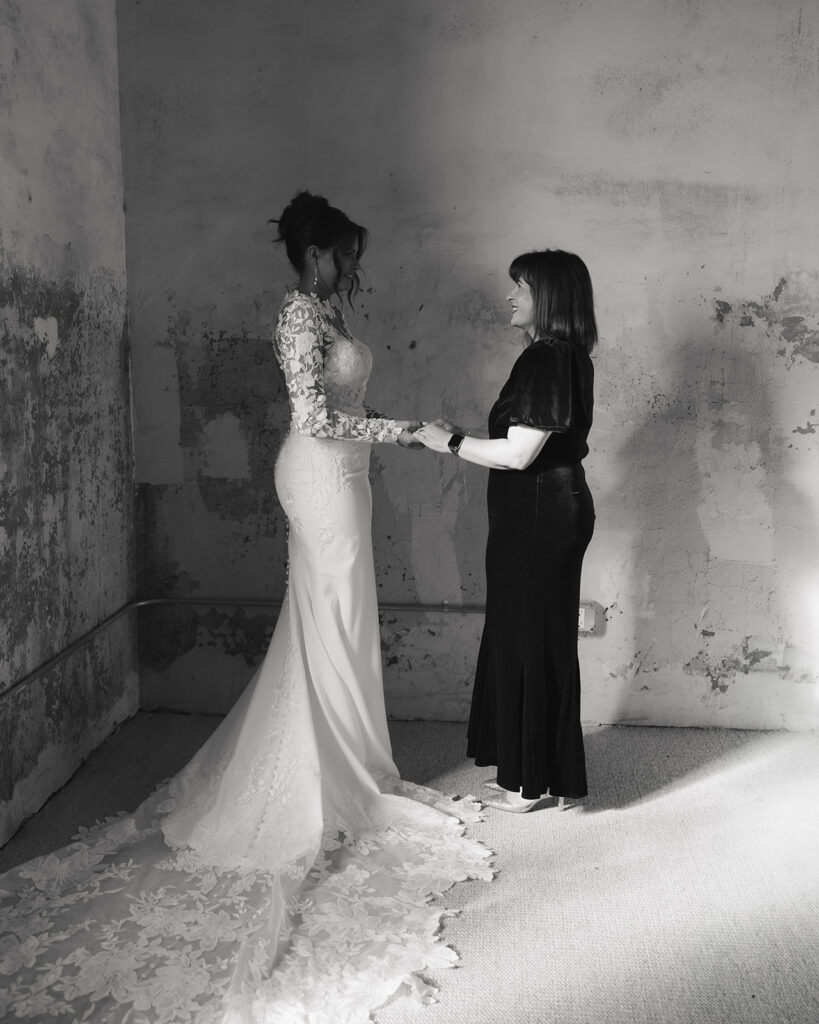 bride and mother share a moment before the wedding