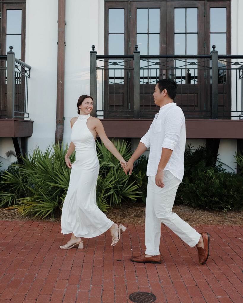 bride and groom walk by the Pearl hotel in Rosemary Beach FL