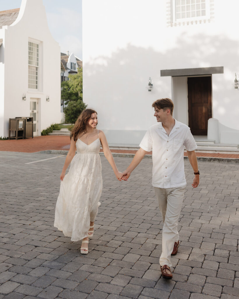 bride and groom walk by the Rosemary Beach town hall
