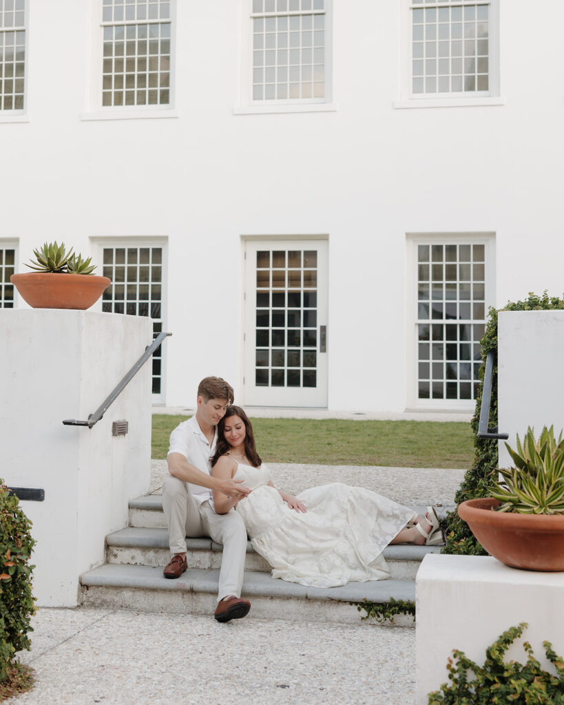 bride and groom sit on the steps of the Rosemary beach town hall