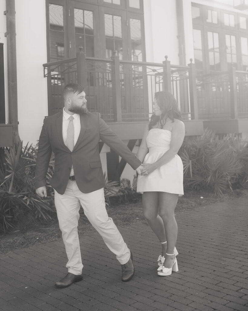 man and woman walk by the Pearl hotel