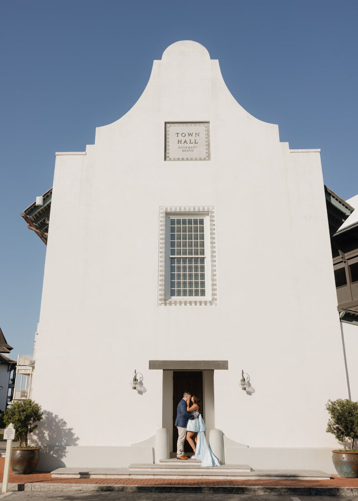 man and woman stand in front of the town hall