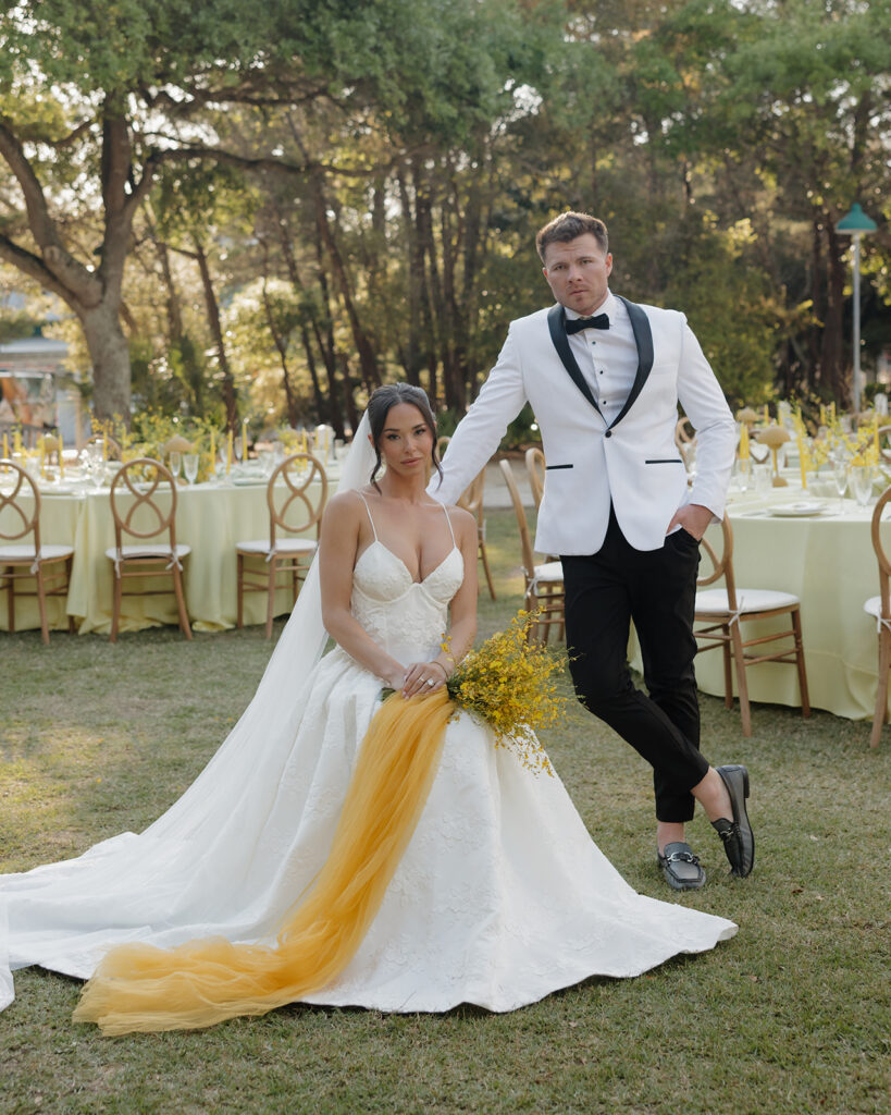 bride and groom pose in their reception space