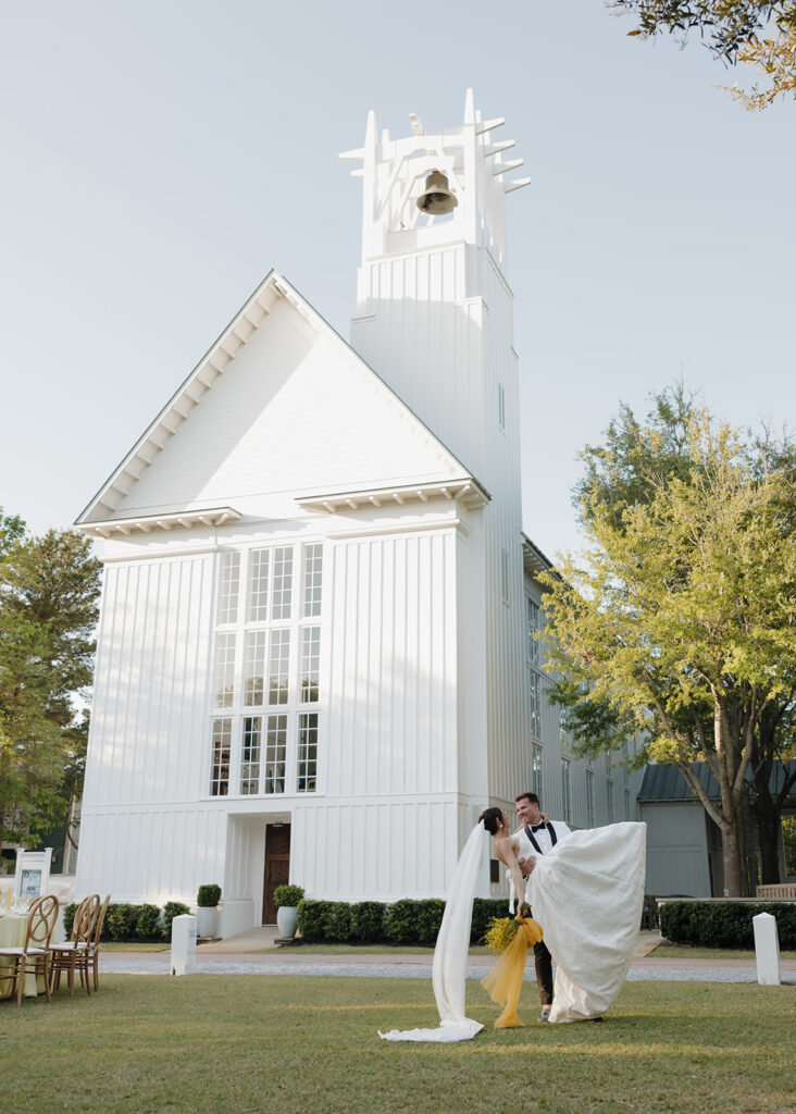 bride and groom dip in front of the Chapel at Seaside