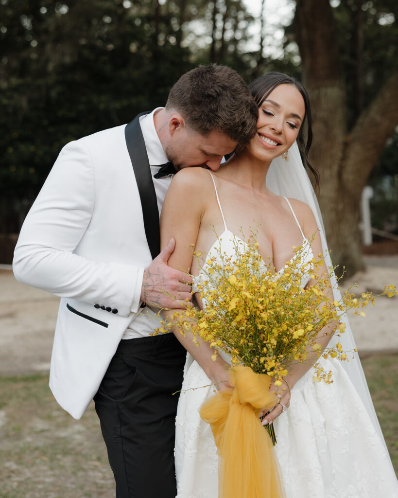 groom kisses bride's shoulder in 30A Florida
