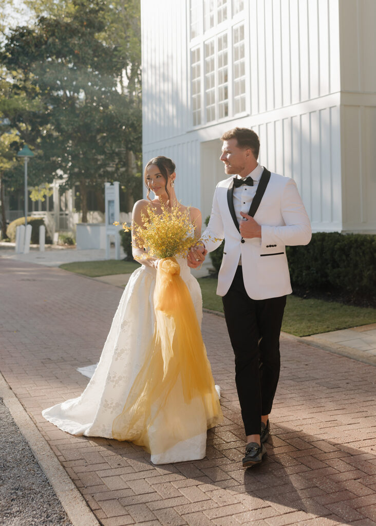 bride and groom walk in Seaside, FL