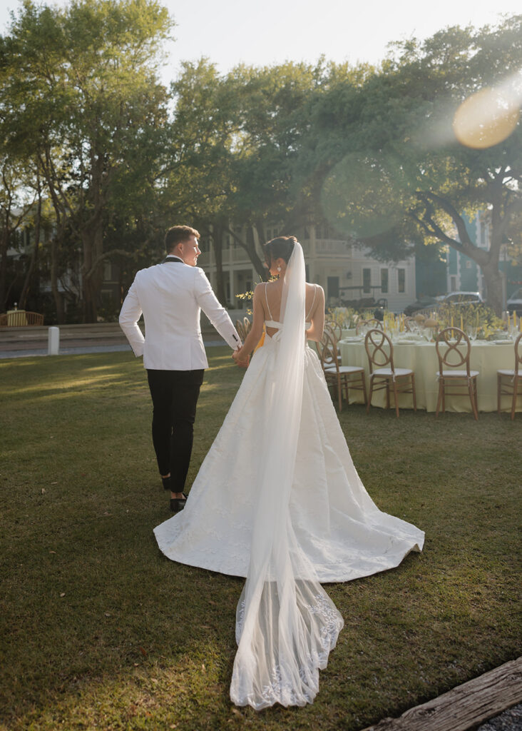 bride and groom walk through the lawn at the Chapel at Seaside