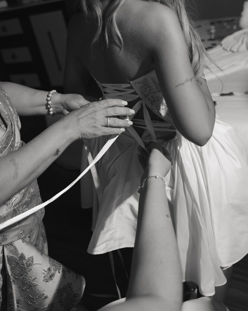 bride steps into reception dress