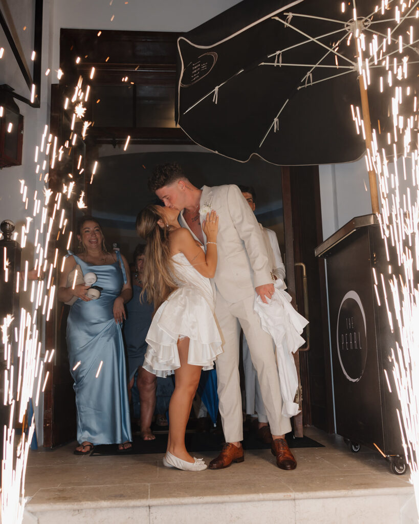bride and groom kiss near cold sparks