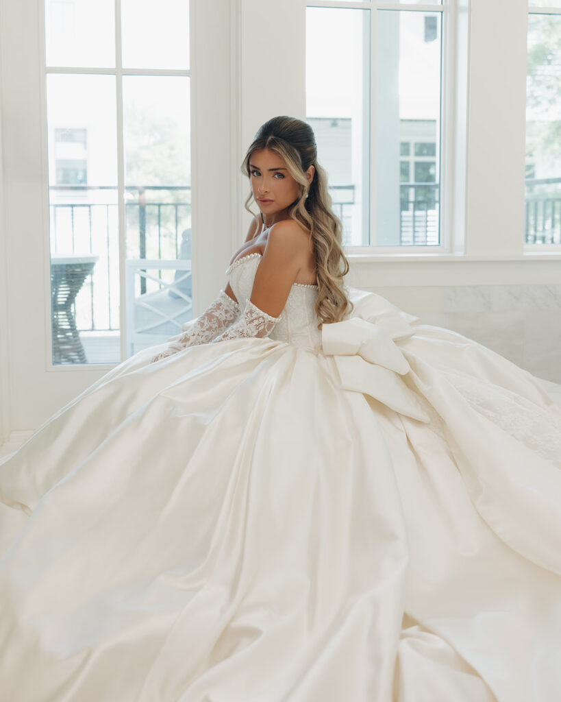 bride poses in pnina tornai wedding dress