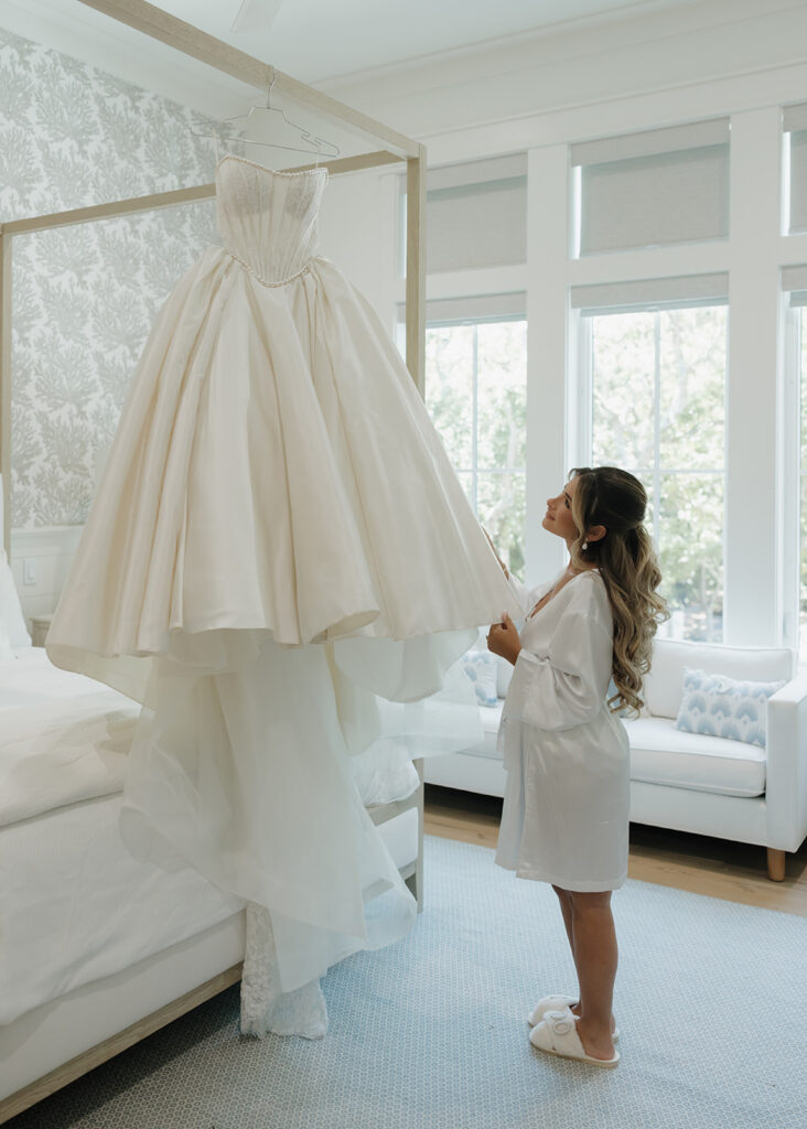 bride looks at her Pnina Tornai wedding dress