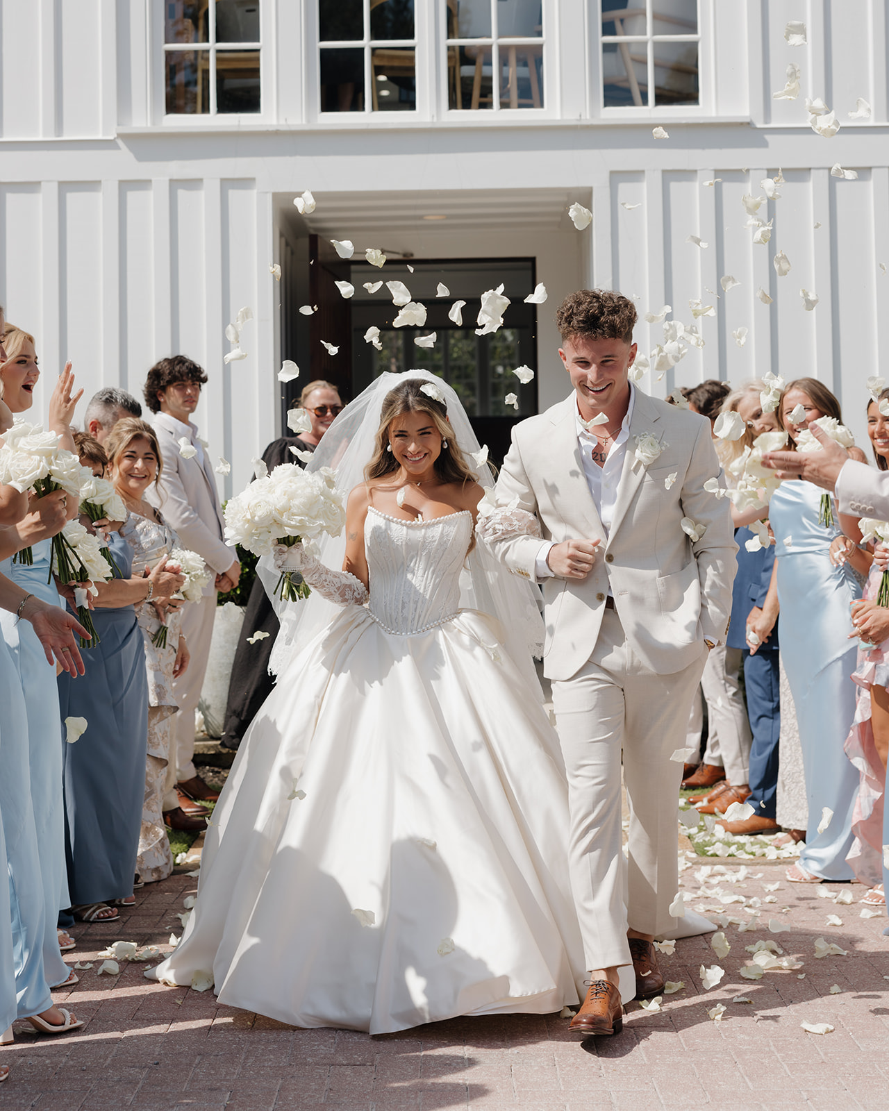 bride and groom walk out of the Chapel at Seaside