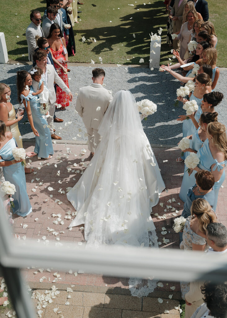 bride and groom walk out of the chapel in 30A Florida