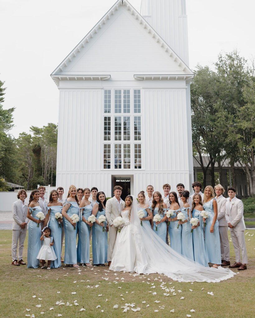 wedding party stands outside of the Seaside Chapel in 30A Florida