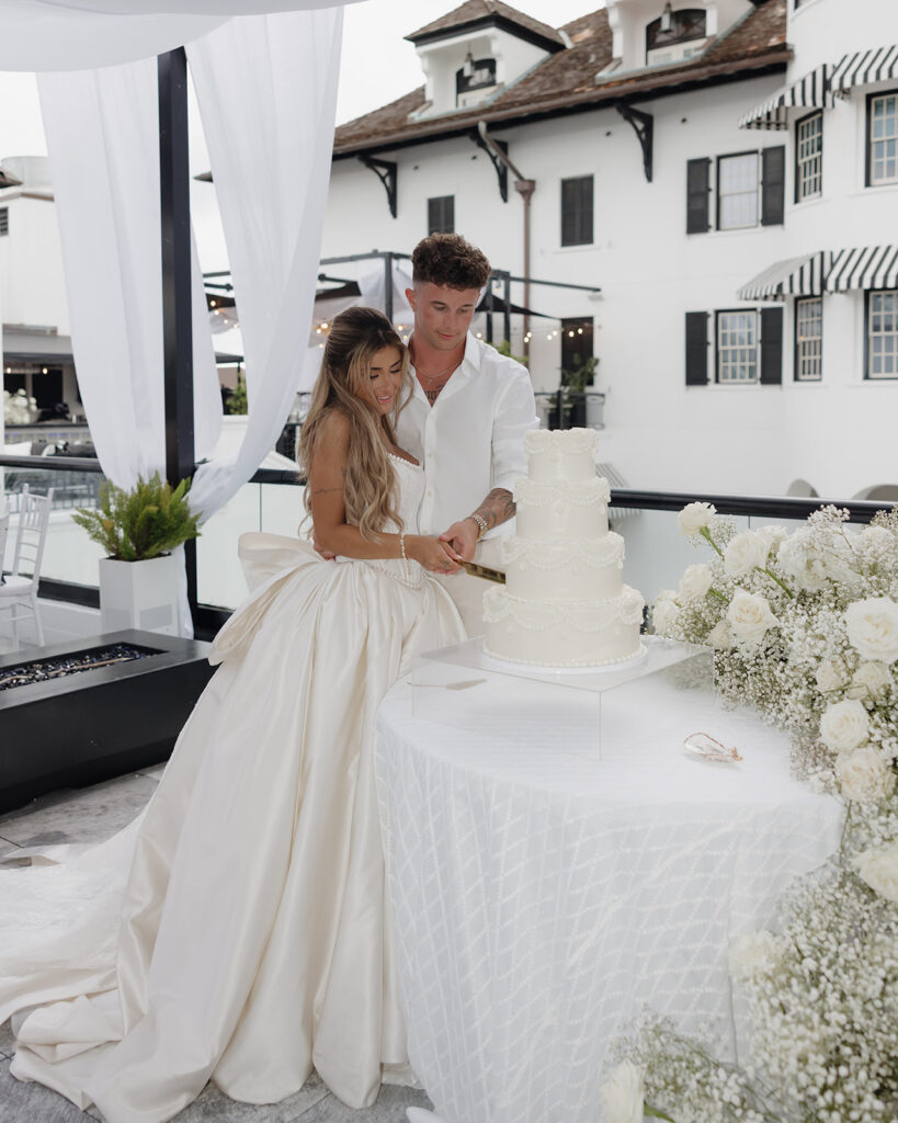 bride and groom cut the wedding cake