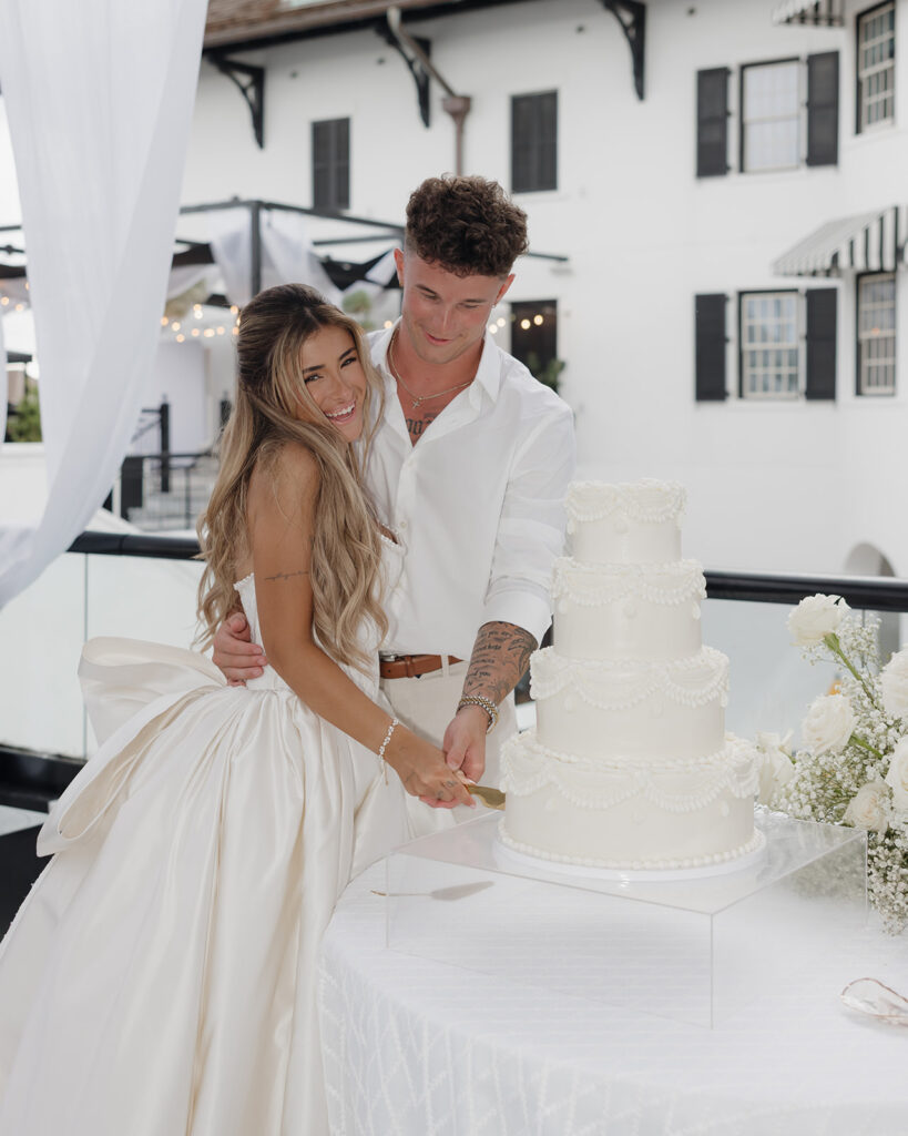 bride and groom cut the wedding cake at the Pearl in Rosemary Beach Florida