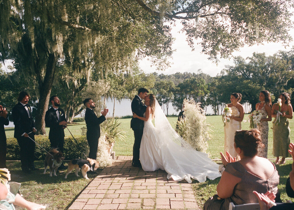 bride and groom share first kiss