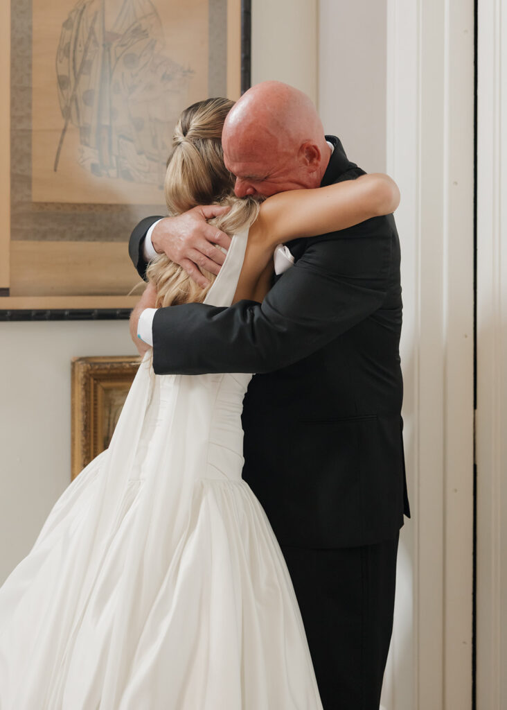 father of the bride hugs his daughter