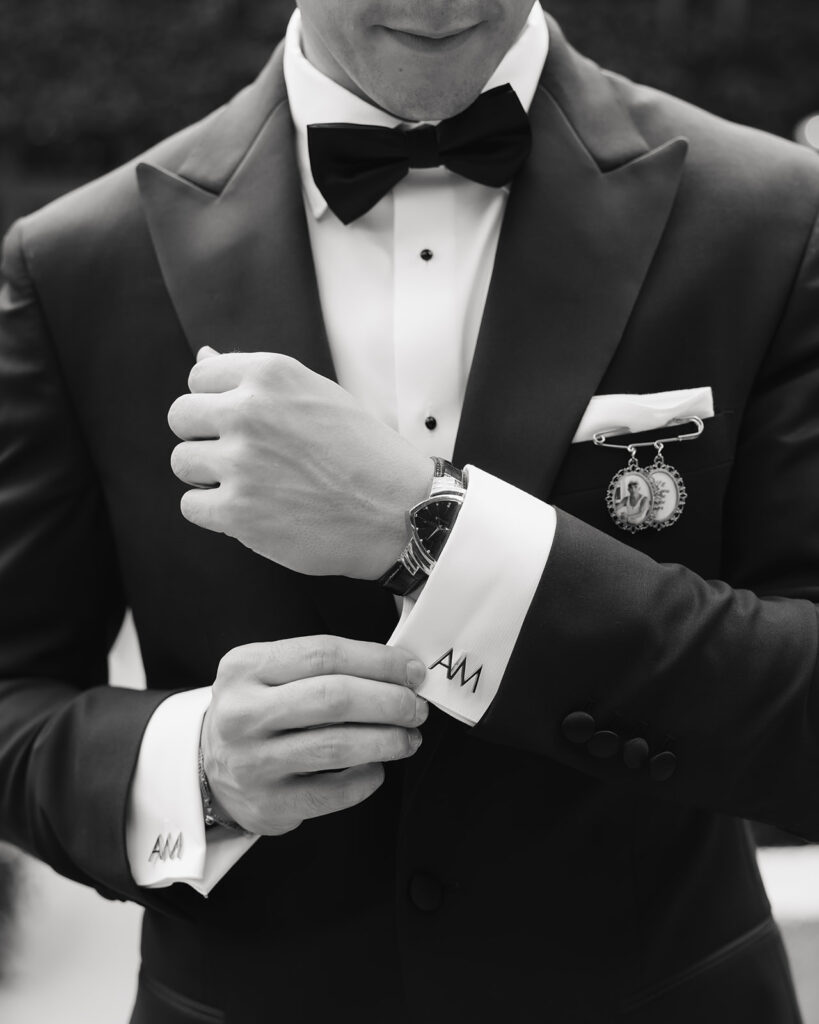 groom adjusts his sleeves