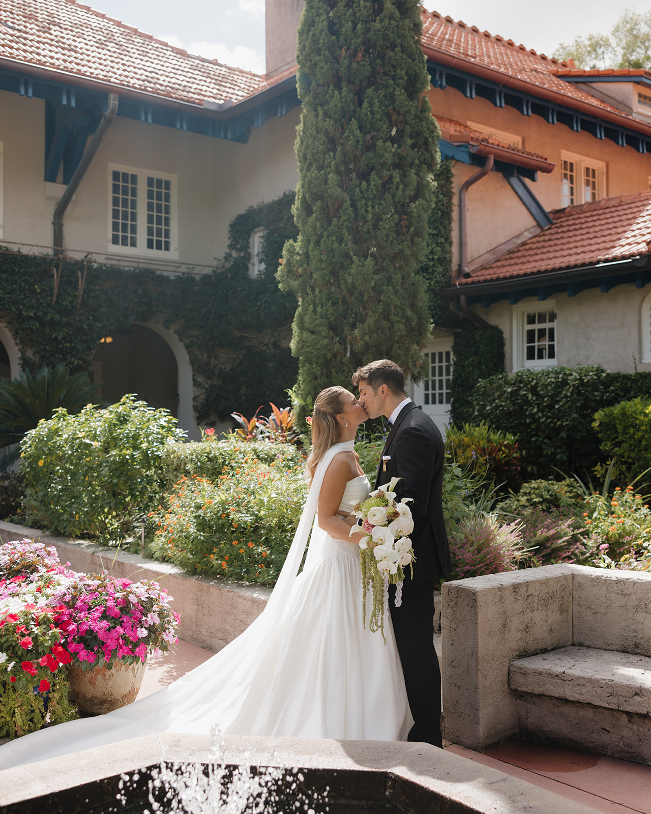 bride and groom kiss in the garden