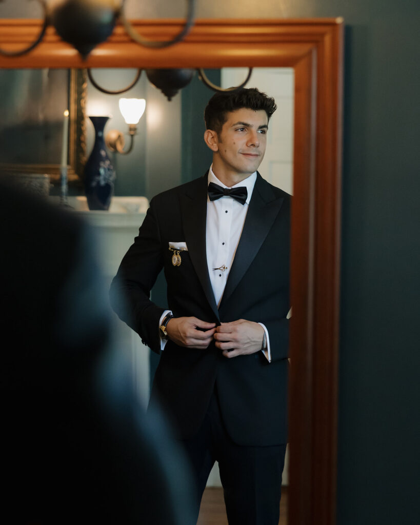 groom buttoning jacket